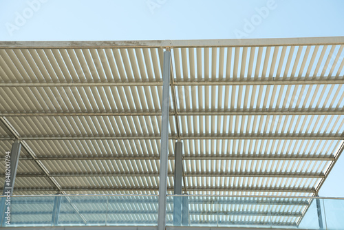 An exterior detail shot of an abstract modern design rooftop shading structure. 