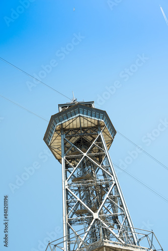 Shot of exterior detail of vintage steel girder structure supporting a funicular tower. 