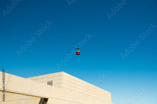 Red funicular cars against blue skies. 