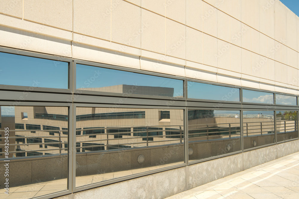 Naklejka premium Reflection of a beautiful modern design office building on a window.