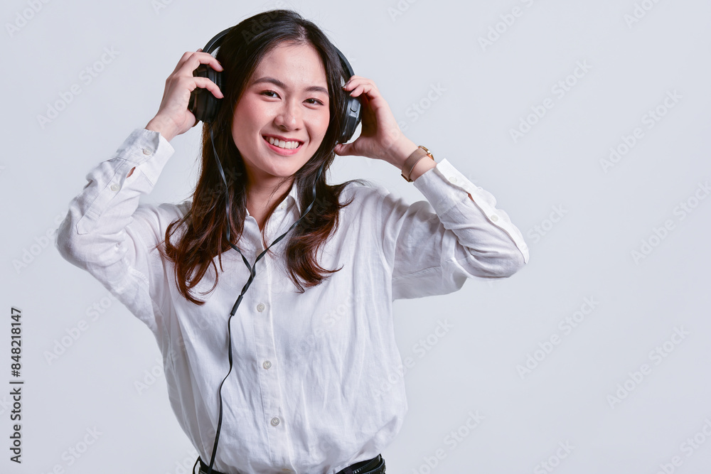 Young Asian business woman with headphones and beautiful smile Young Asian business woman with headphones and beautiful smile