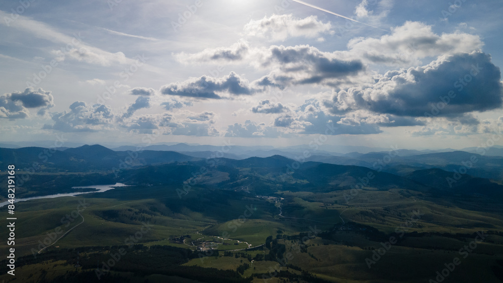 Aerial panoramic view of the Ribnicko lake located in Zlatibor, Serbia. Beautiful scenery in the National Park on a moody day with grey skies and low clouds and dramatic clouds. Aerial panoramic view of the Ribnicko lake located in Zlatibor, Serbia. Beautiful scenery in the National Park on a moody day with grey skies and low clouds and dramatic clouds.