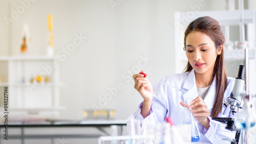 Canvastavla Attractive young Asian scientist woman lab technician assistant analyzing sample in test tube at laboratory