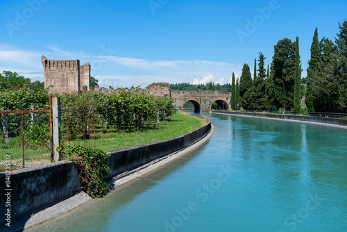 the Visconteo Bridge in Borghetto sul Mincio Visconteo is a fortified dam that was built in 1393 and completed in 1395 at the behest of the Duke of Milan Gian Galeazzo Visconti. photo