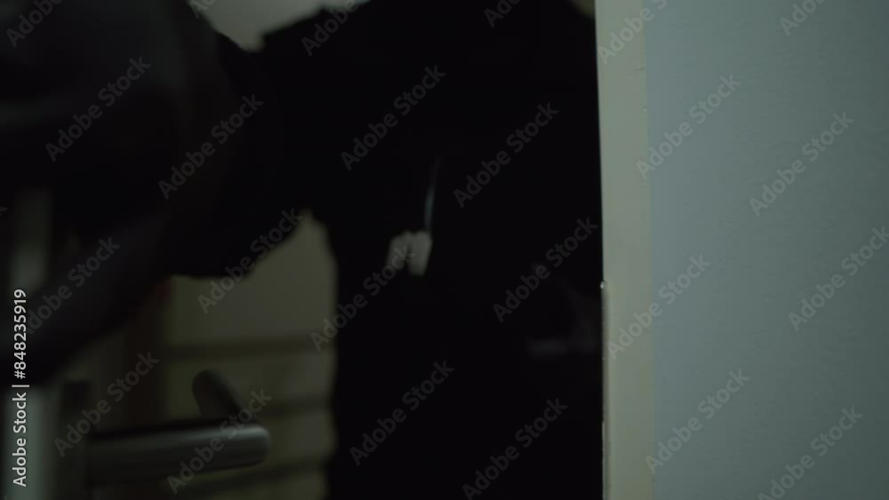 Close-up of hands with black gloves of a male thief holding crowbar while entering the apartment, home security to prevent the crimination, criminal impact on economic society.
Close-up of hands with black gloves of a male thief holding crowbar while entering the apartment, home security to prevent the crimination, criminal impact on economic society.