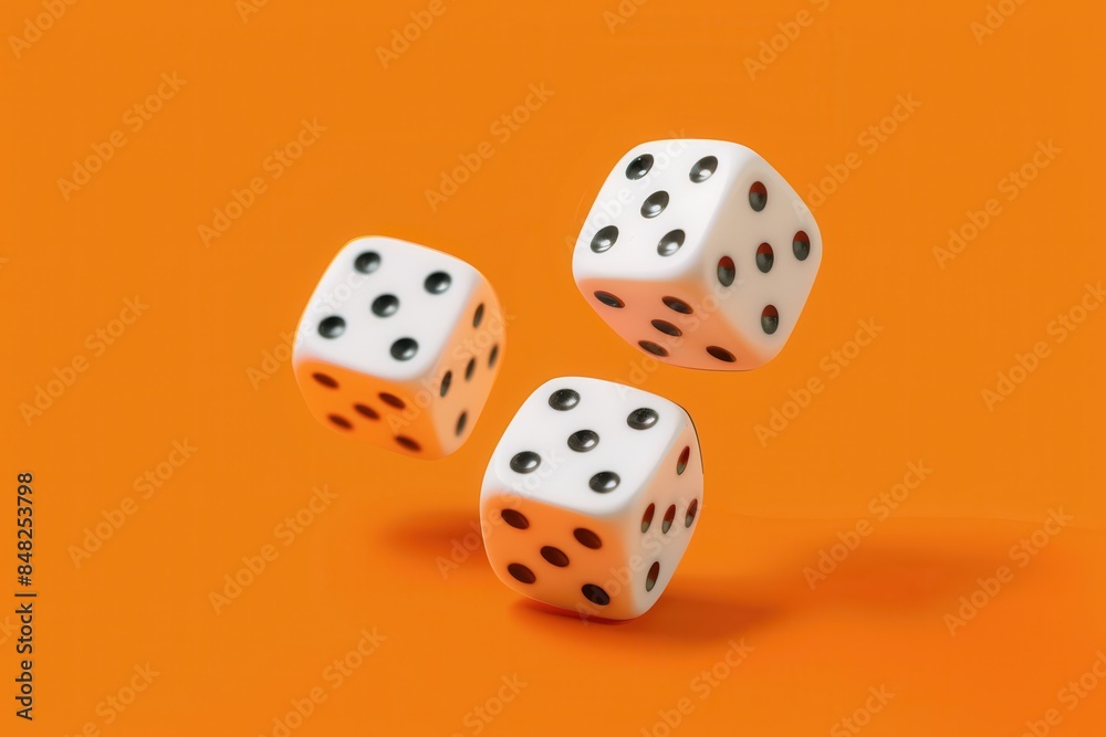White dice captured in motion against an orange backdrop, with a blurred area in the center White dice captured in motion against an orange backdrop, with a blurred area in the center