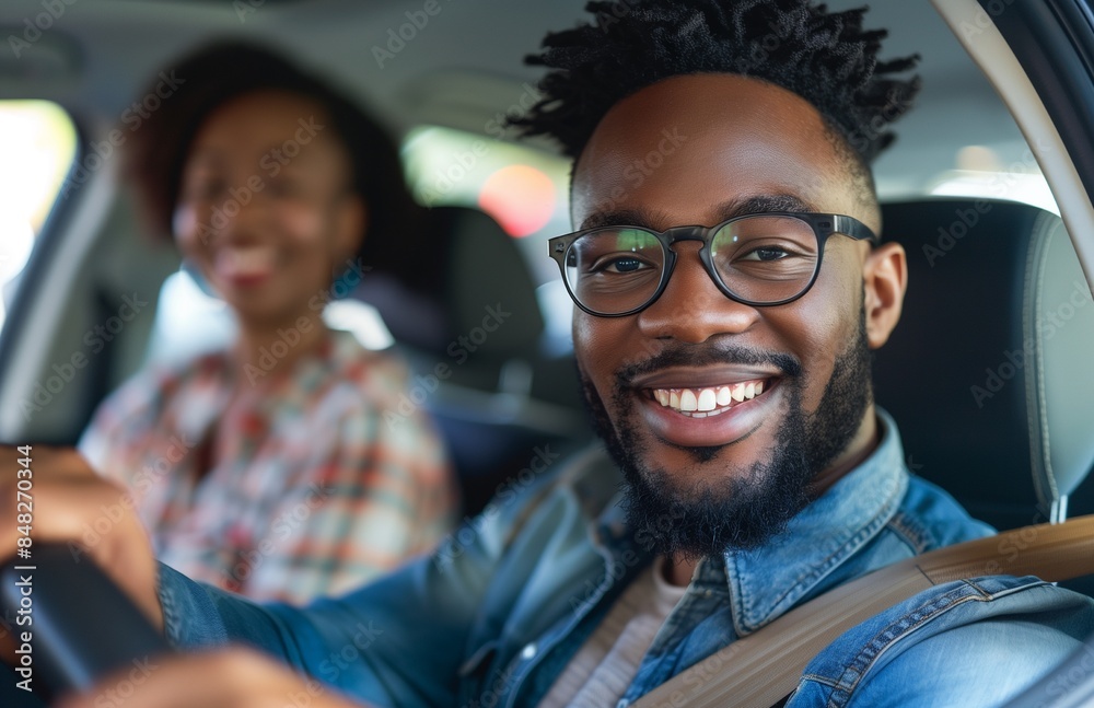 cheerful man drives his family, smiling at the camera, sitting in the front seat on the right cheerful man drives his family, smiling at the camera, sitting in the front seat on the right