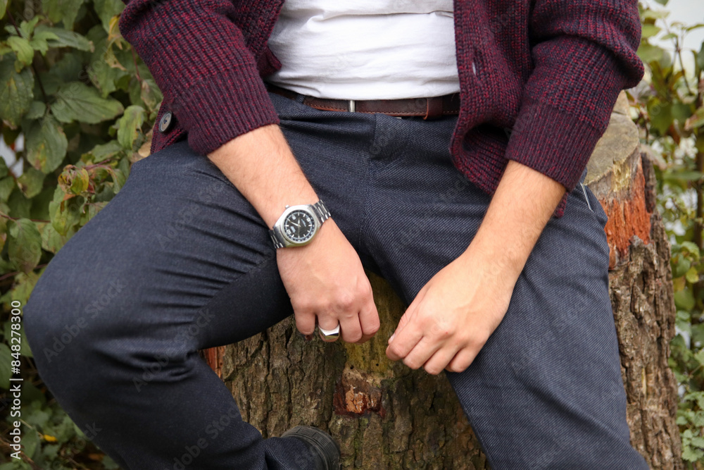 Close-up of man's hands with fashionable watch and ring. Stylish man with autumn accessories and trendy watch. Stylish man autumn outside Close-up of man's hands with fashionable watch and ring. Stylish man with autumn accessories and trendy watch. Stylish man autumn outside
