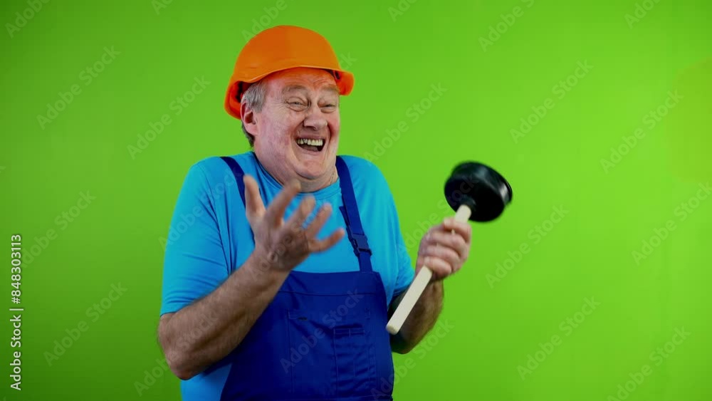 Senior worker in in overalls laughing and pointing index finger some one. Senior worker in in overalls laughing and pointing index finger some one.