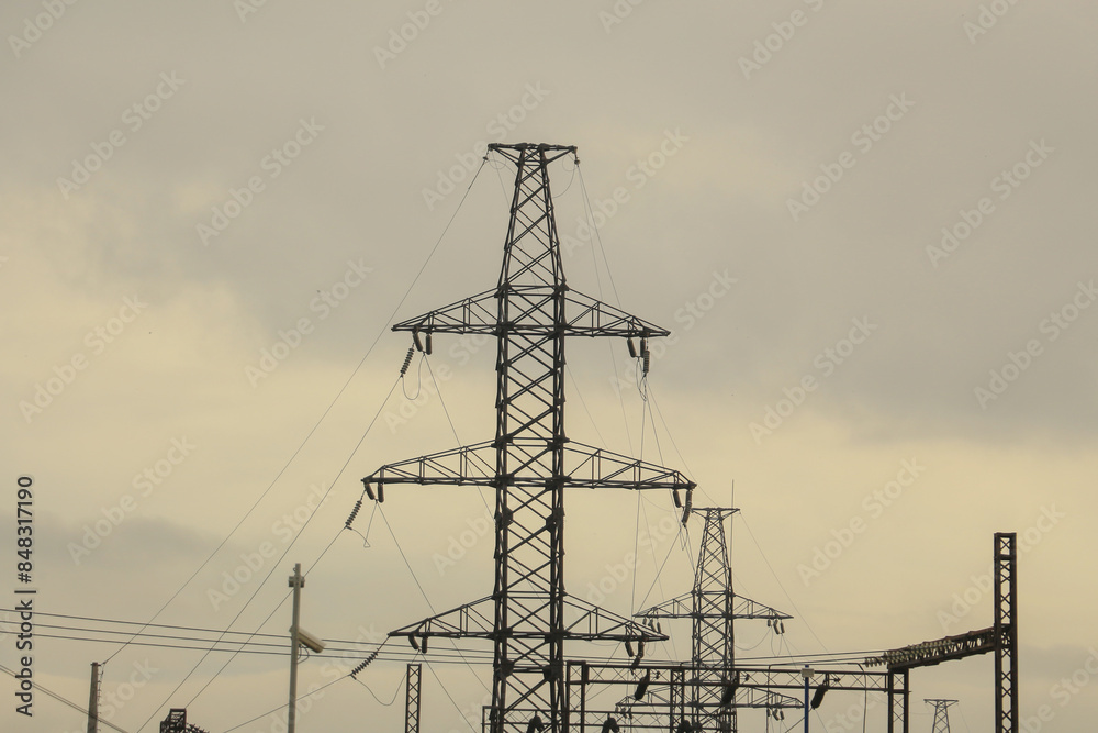 industrial landscape: high power transmission towers against a cloudy sky industrial landscape: high power transmission towers against a cloudy sky