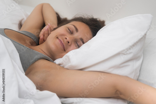 Morning Euphoria: A woman greets the day with open arms, beaming after a restful night's sleep. 