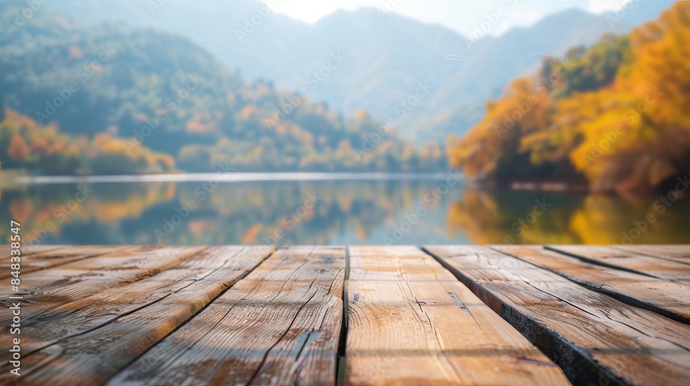 Wooden deck overlooking a tranquil lake with mountains and autumn foliage in the background, perfect for nature and relaxation themes. Wooden deck overlooking a tranquil lake with mountains and autumn foliage in the background, perfect for nature and relaxation themes.