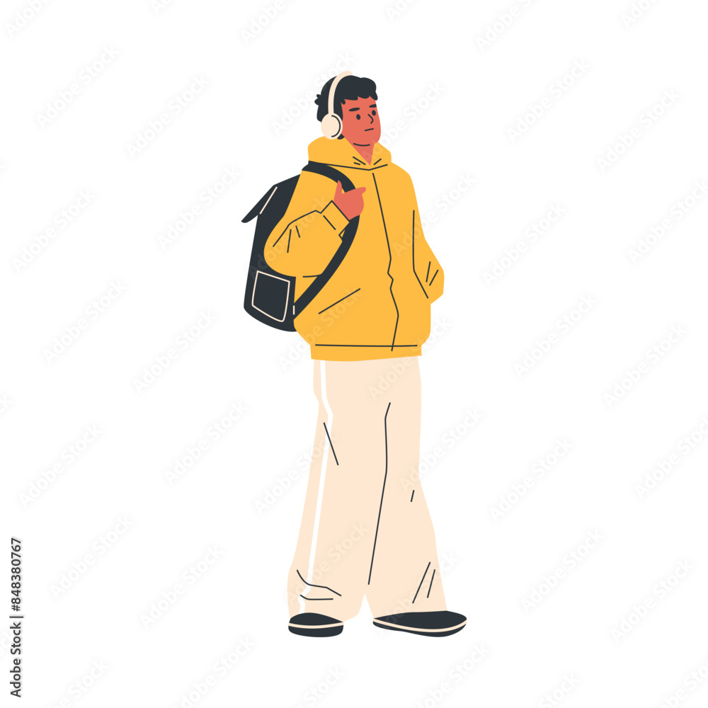 A young man in a yellow tracksuit with headphones. Isolated background. A young man in a yellow tracksuit with headphones. Isolated background.