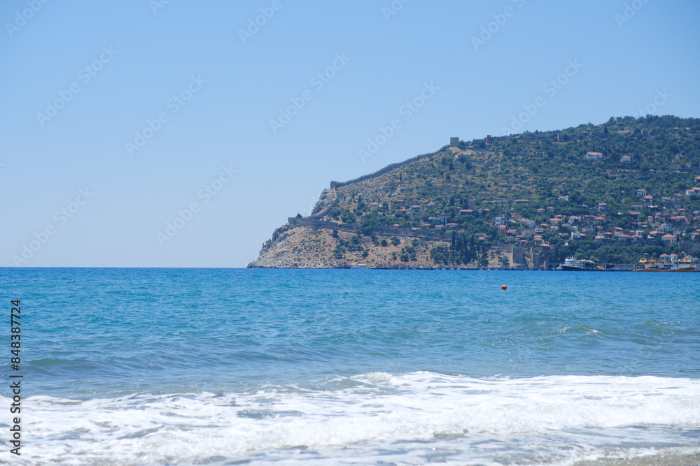 Mediterranean seaside coast in calm weather on blue sky background. Mediterranean seaside coast in calm weather on blue sky background.