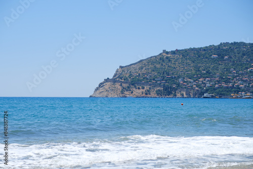 Fototapeta Naklejka Na Ścianę i Meble -  Mediterranean seaside coast in calm weather on blue sky background.