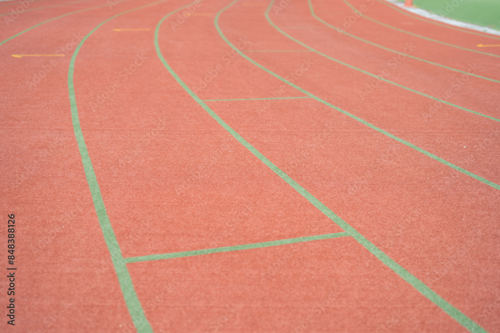 Fototapeta premium Rubber floor, red running track on a sports stadium with grandstand. Sport and recreation background.