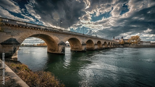 Pont De Pierre over Garonne River against cloudy sky in city photo