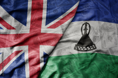 Obraz na plátně big waving colorful flag of lesotho and national flag of great britain on the dollar money background