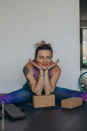 Attractive young woman practing yoga stretching yoga at home.  photo