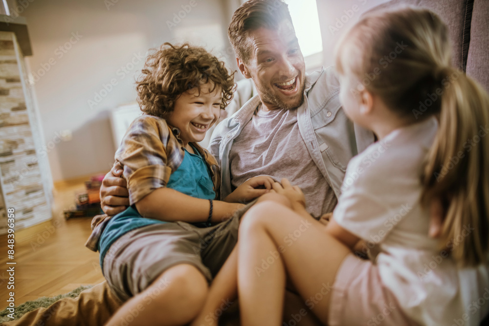 Happy father playing with son and daughter at home Happy father playing with son and daughter at home