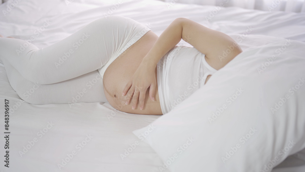 A Portrait of happy Asian pregnant woman in bedroom at home. Having a baby. Family people lifestyle. Love. A Portrait of happy Asian pregnant woman in bedroom at home. Having a baby. Family people lifestyle. Love.
