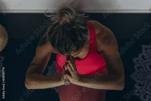 Attractive young woman practing yoga stretching yoga at home.  photo