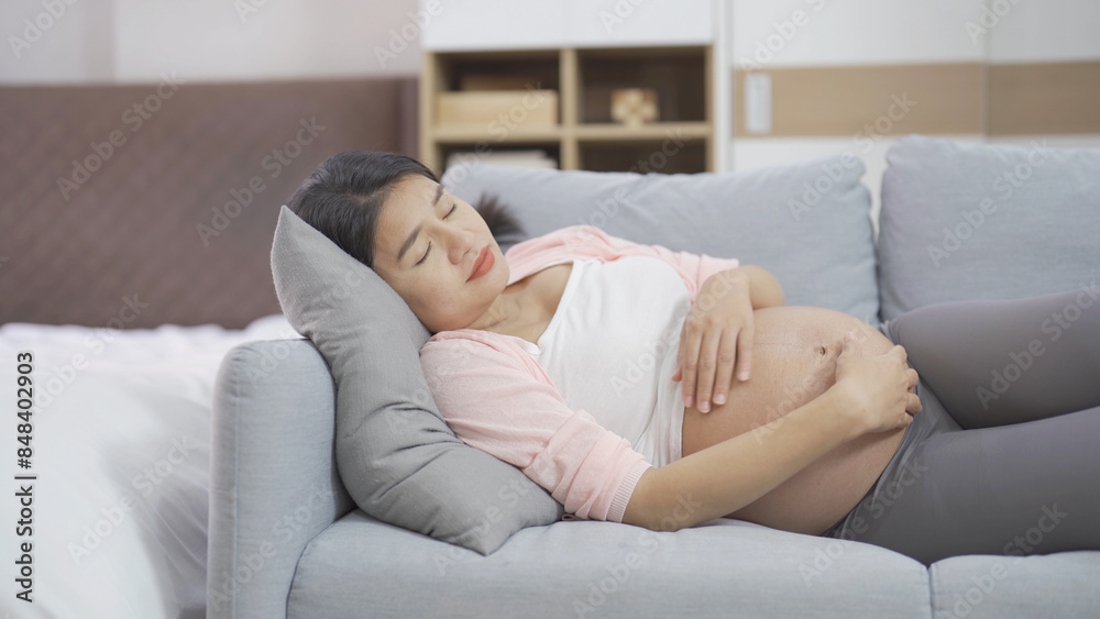 A Portrait of happy Asian pregnant woman in bedroom at home. Having a baby. Family people lifestyle. Love. A Portrait of happy Asian pregnant woman in bedroom at home. Having a baby. Family people lifestyle. Love.