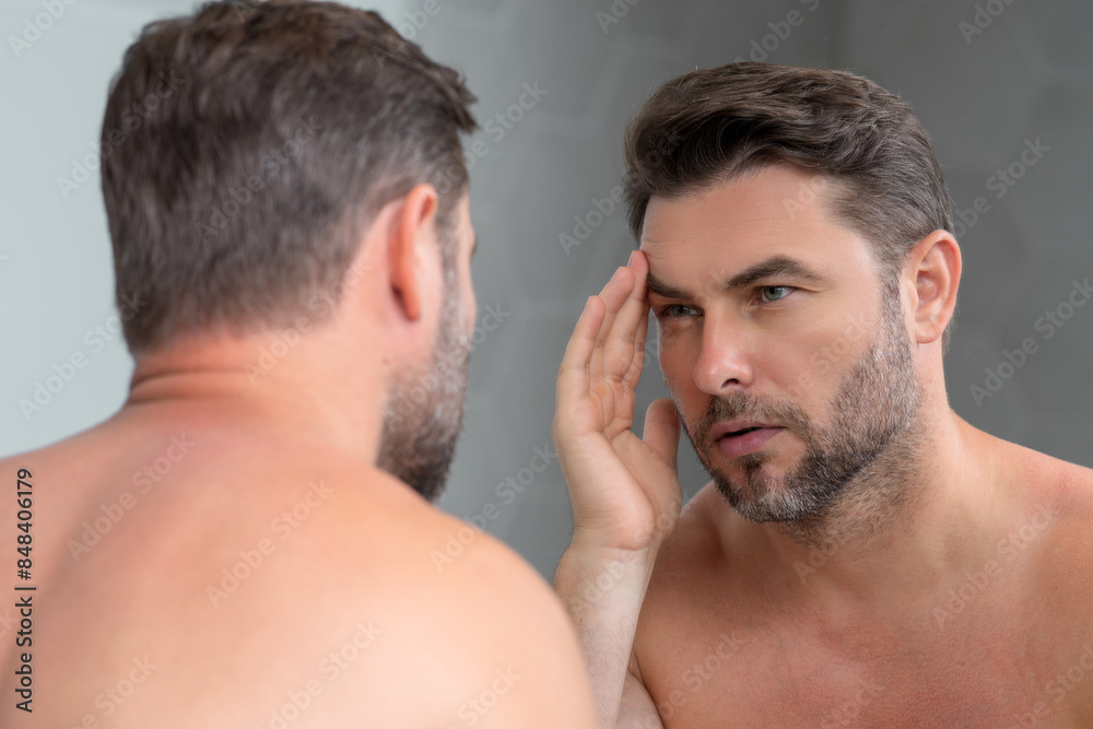 Obraz premium Cosmetic cream for man. Spa male model, skincare product for mens skin. Morning mask for skin with anti-aging effect. Skin care. Male face cream. Man with perfect soft skin. Beauty cosmetic product.