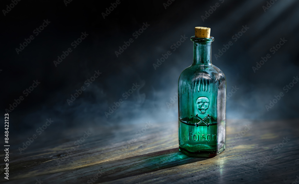 Glass poison bottle with skull and bones. Concept background on poison poisoning, pharmaceutical, chemistry, medical, old science topic. Poison, venom, toxin, toxic, bane, virus background. Glass poison bottle with skull and bones. Concept background on poison poisoning, pharmaceutical, chemistry, medical, old science topic. Poison, venom, toxin, toxic, bane, virus background.