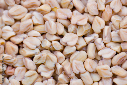 Close-up image of split fenugreek seeds, also known as Methi Kuria, which are cracked fenugreek seeds commonly used in Indian pickle recipes. photo