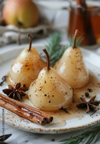 Three Poached Pears With Cinnamon and Star Anise on a White Plate