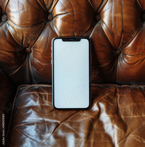 Modern Smartphone Laying on a Brown Leather Couch