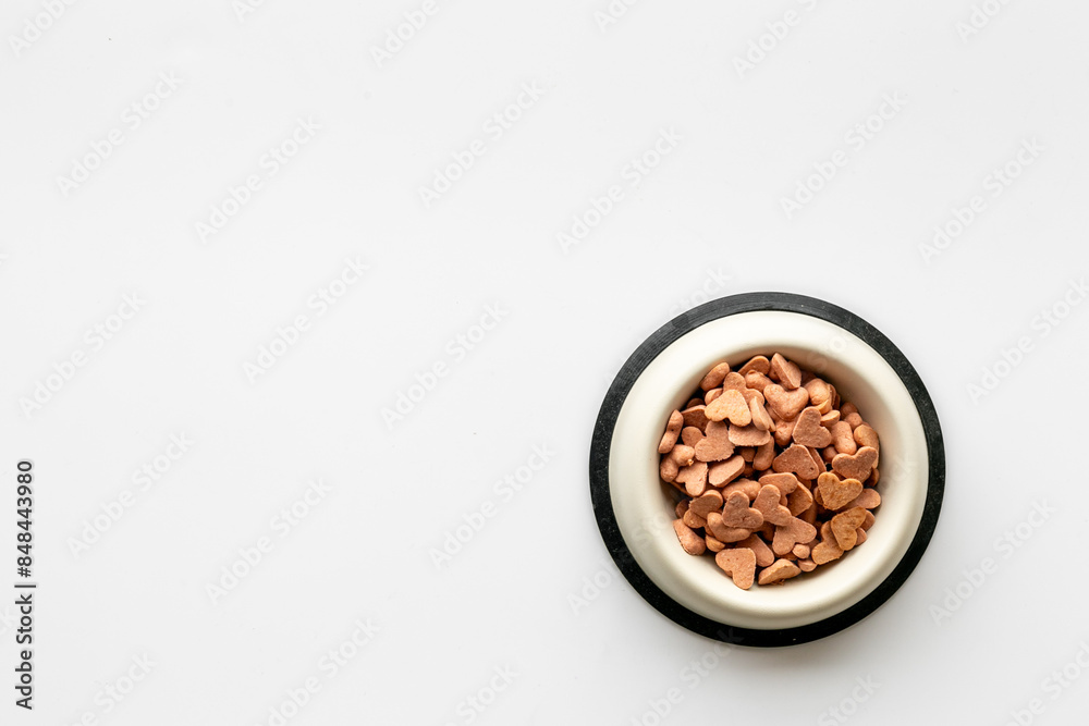 Food and treats for pets - biscuits in a shape of heart in a bowl Food and treats for pets - biscuits in a shape of heart in a bowl