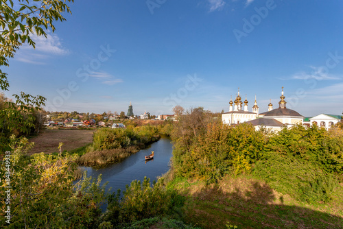 Suzdal, Vladimir region, Russia, Golden Ring - Panorama of the city. The bend of the river and all the famous churches of the city: the bell tower of the Ordinatorsky convent, Lazarevskaya, Assumption photo