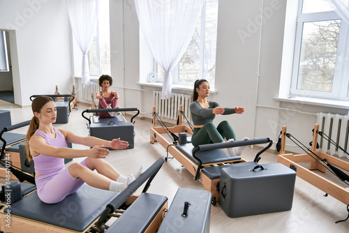 Group of people sitting on pilates in a room. © LIGHTFIELD STUDIOS