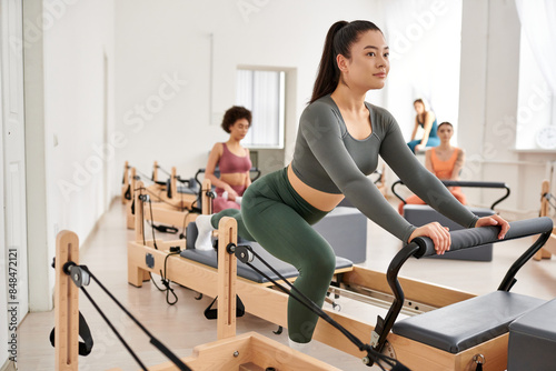 Attractive group of sporty women engaging in a pilates workout at the gym. © LIGHTFIELD STUDIOS