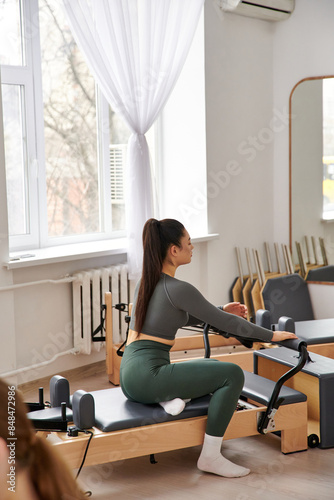 A sporty woman engaging in a pilates lesson.