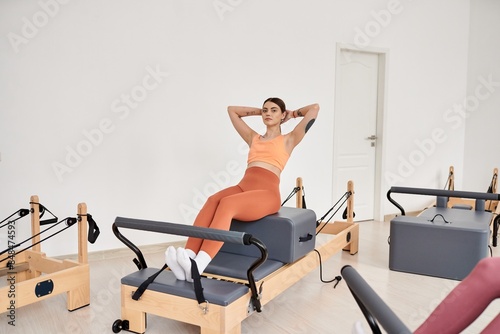 Alluring sporty woman practicing pilates with focus and determination. photo