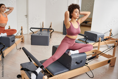 A dynamic group of sporty women engage in a Pilates lesson.