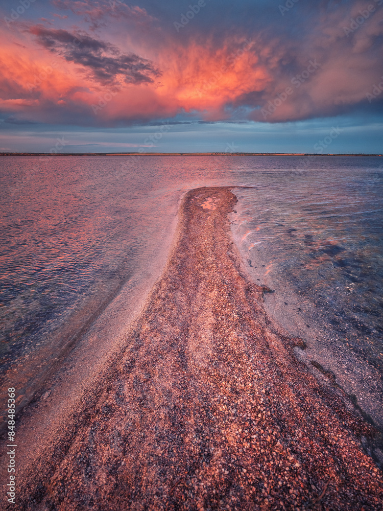 Obraz na plátně portrait view to sand spit in pink-orange colours after sunset