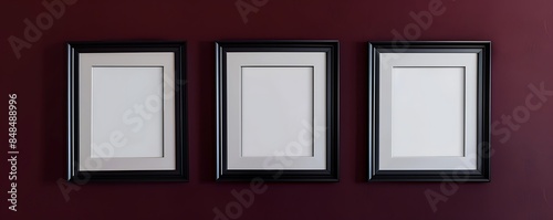 Trio of satin black frames against a dark crimson wall, elegant and modern gallery setup, HD captured,