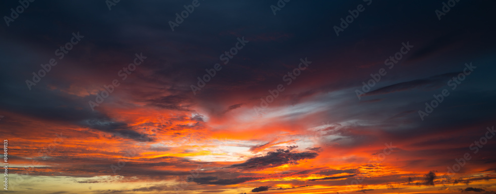 Fototapeta premium Sunrise background. Dramatic majestic scenery sunset. Sky with clouds in Sunrise sky light background. Sunrise with clouds in various shapes. Calm Sunrise sky and sun through clouds over.