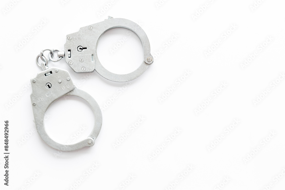 Police metal handcuffs top view. Criminal offense and detention concept Police metal handcuffs top view. Criminal offense and detention concept