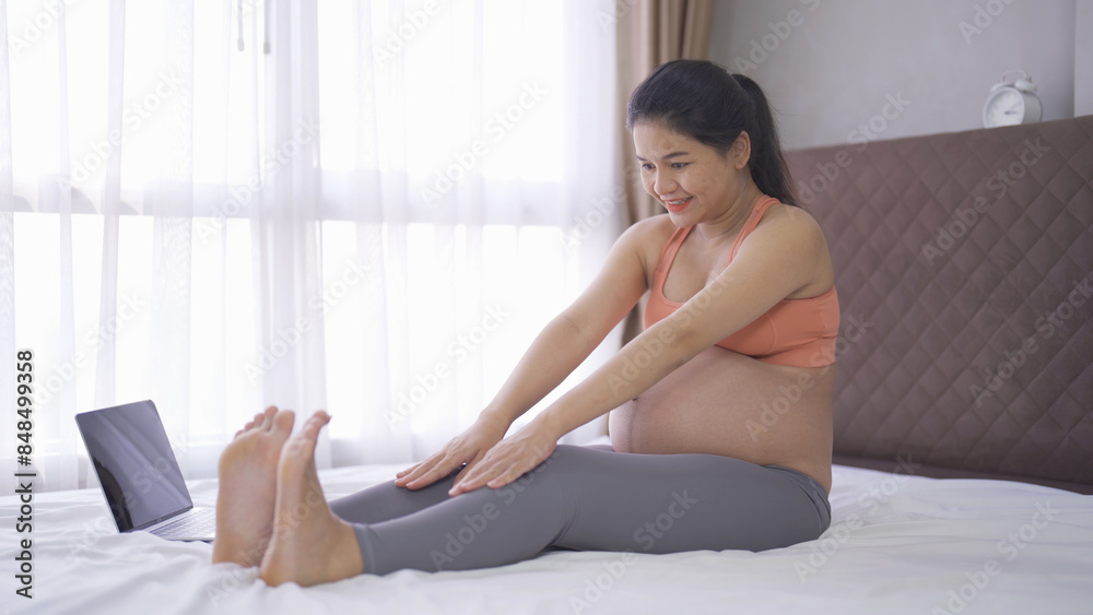 A portrait of happy Asian pregnant woman in bedroom at home. Having a baby. Training workout. Exercise indoor with sport equipment. Athletic. Family people lifestyle. Mom love. Recreation. A portrait of happy Asian pregnant woman in bedroom at home. Having a baby. Training workout. Exercise indoor with sport equipment. Athletic. Family people lifestyle. Mom love. Recreation.