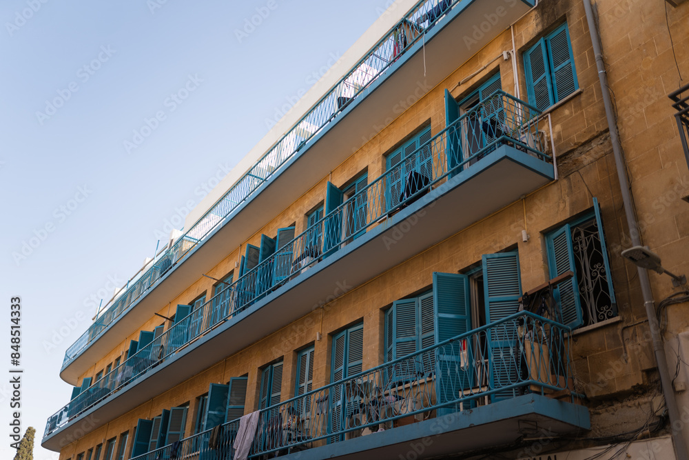 Cute and bohemian blue old balconies facade,wood windows in resident area of Nicosia Cute and bohemian blue old balconies facade,wood windows in resident area of Nicosia