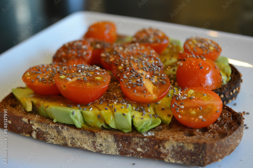 A delicious and nutritious meal featuring Healthy Avocado Toast with Cherry Tomatoes and Chia Seeds. Healthy eating A delicious and nutritious meal featuring Healthy Avocado Toast with Cherry Tomatoes and Chia Seeds. Healthy eating