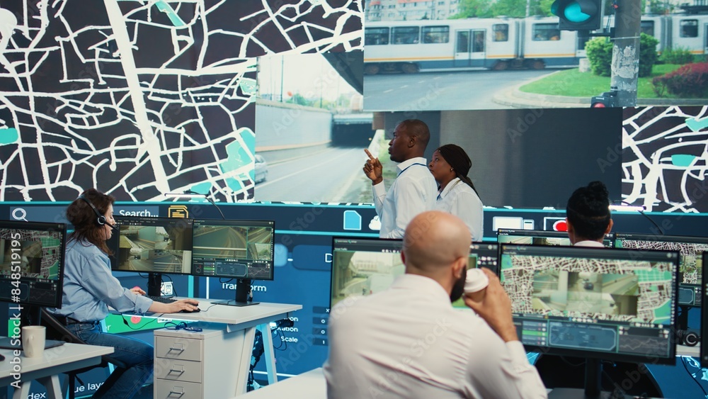 Employees team monitoring delivery cars in traffic via CCTV radar footage at stop lights, using satellite navigation for order tracking information. Cargo logistics around the city. Camera B. Employees team monitoring delivery cars in traffic via CCTV radar footage at stop lights, using satellite navigation for order tracking information. Cargo logistics around the city. Camera B.