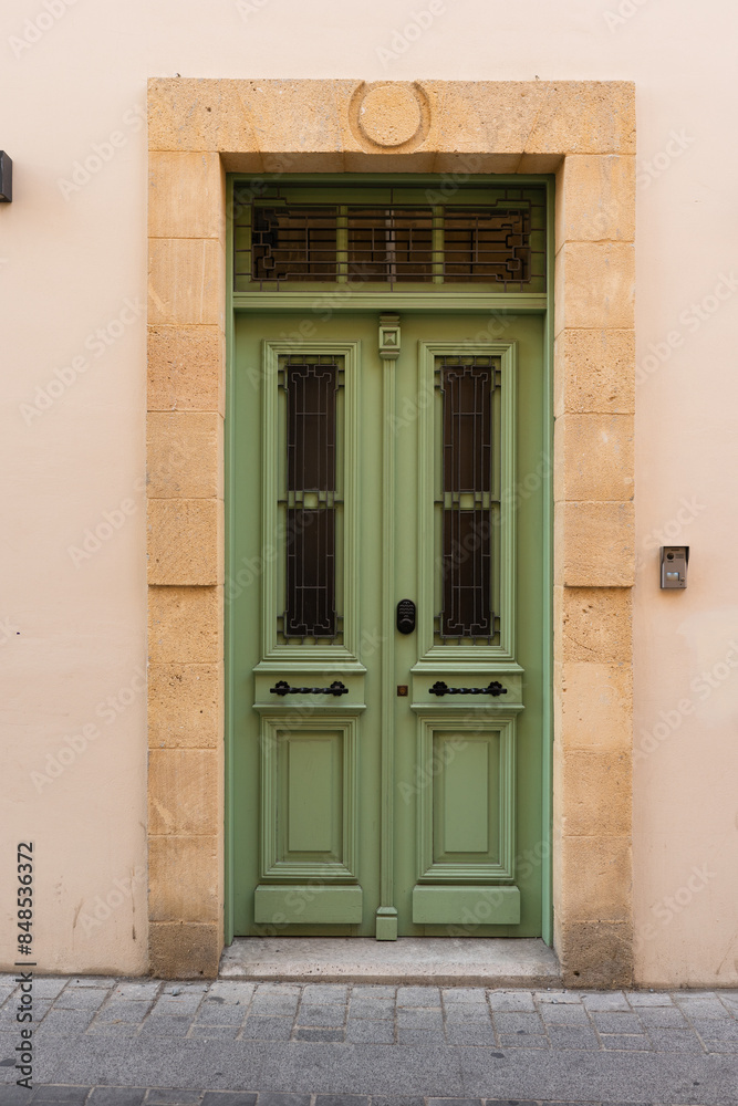 House facade with Mediterranean styled green door House facade with Mediterranean styled green door