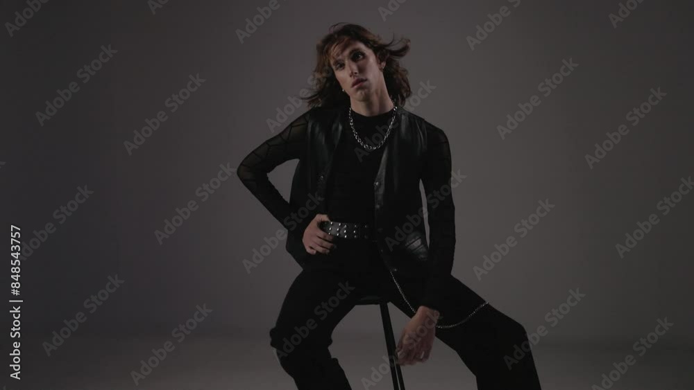Stylish Male Model On Chair In Studio. Stylish Male Model On Chair In Studio.