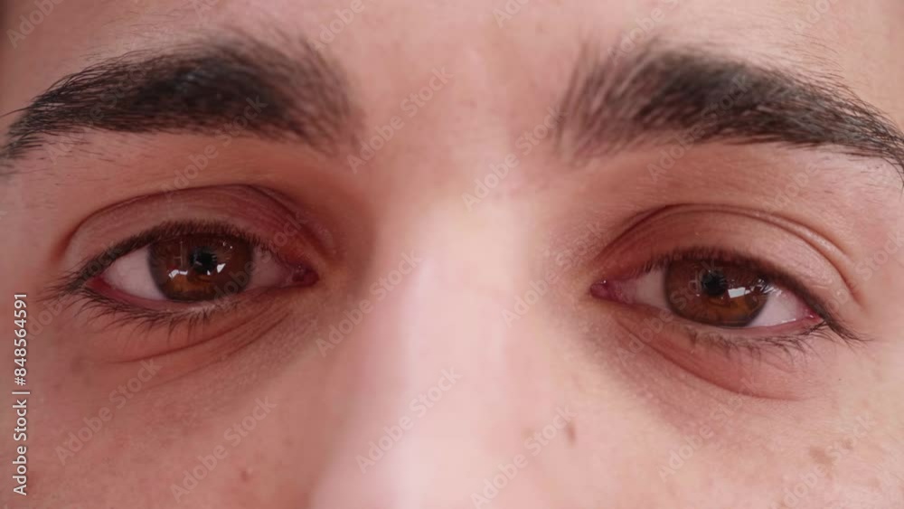 A close-up of a young man's eyes, initially closed and then opening slowly, as if unveiling a world of dreams and aspirations hidden within, reflecting hope and curiosity